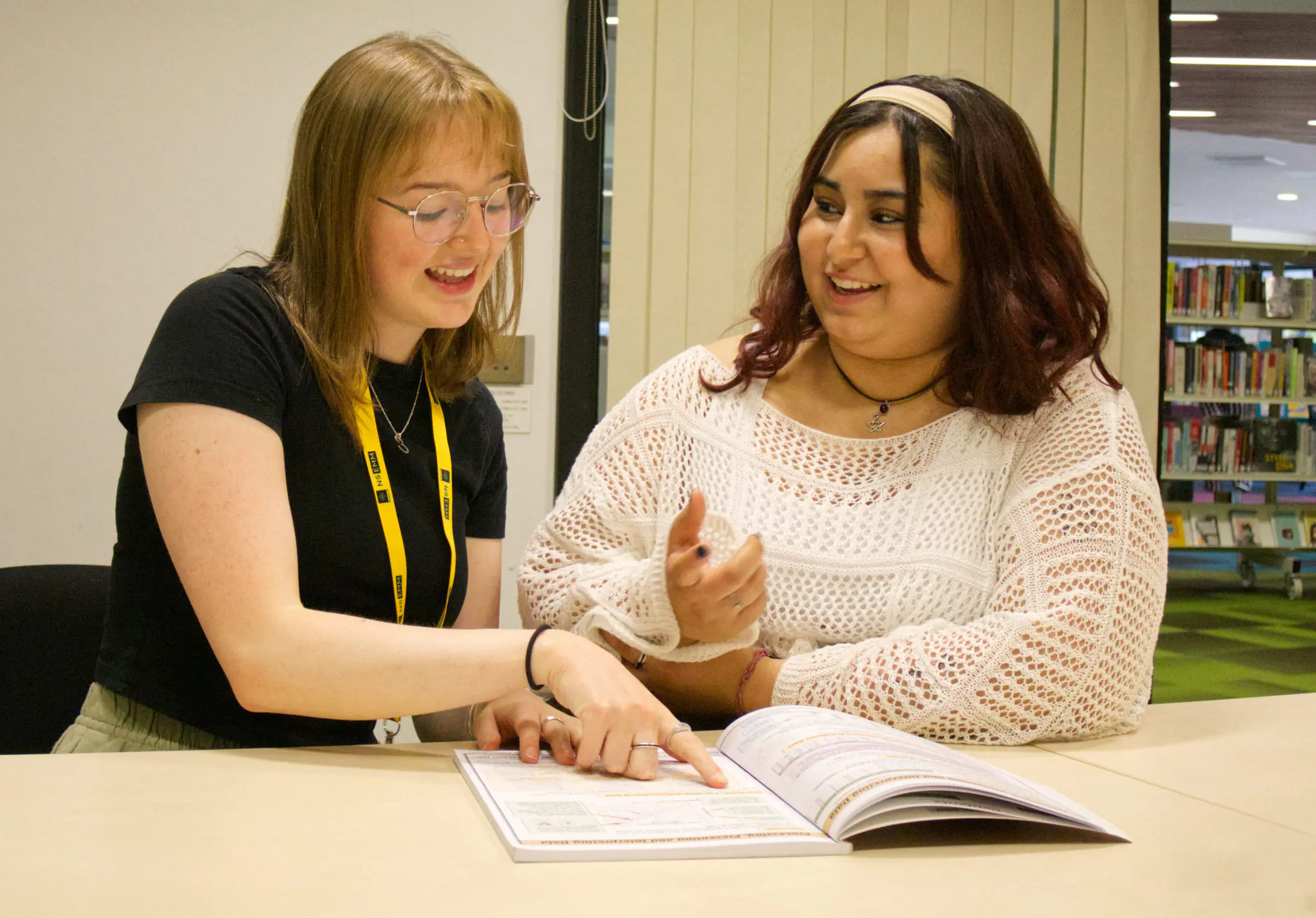 Two students at a library table
